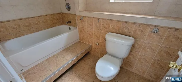 a bathroom with a toilet and a bathtub