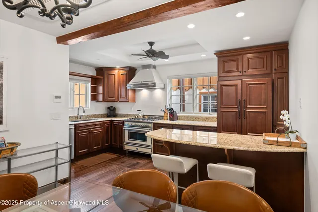 a large kitchen with cabinets a sink and a stove