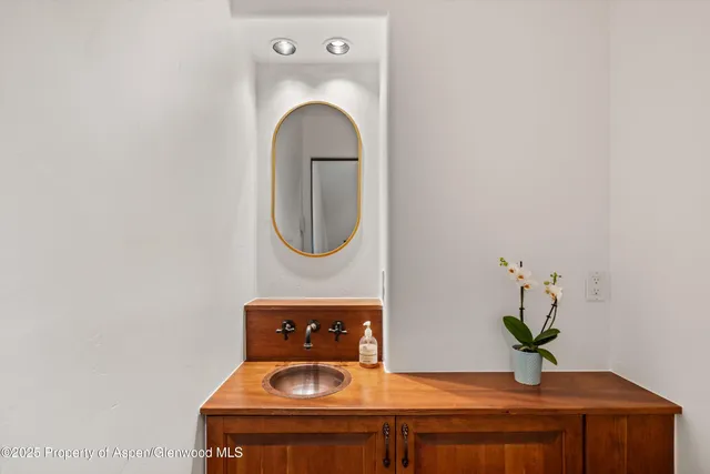 a close view of a utility room with a sink and a mirror