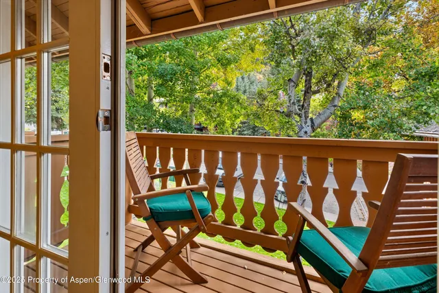 a wooden bench sitting in front of a building