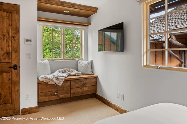 a bed room with a bed and a window