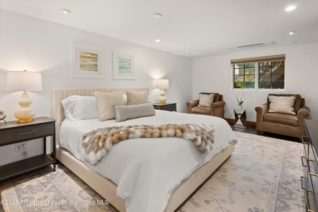 a large bedroom with a bed and a couch