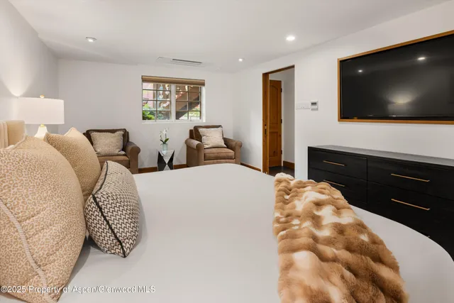 a bedroom with a bed and a flat screen tv