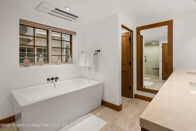 a bathroom with a sink a mirror and a bathtub