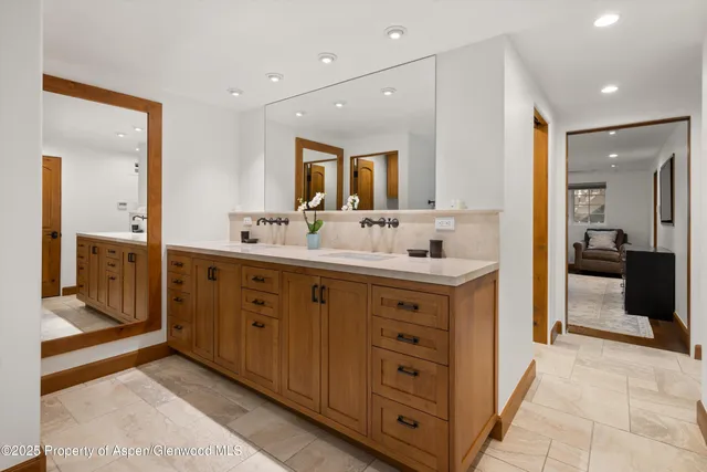 a bathroom with a double vanity sink mirror and double