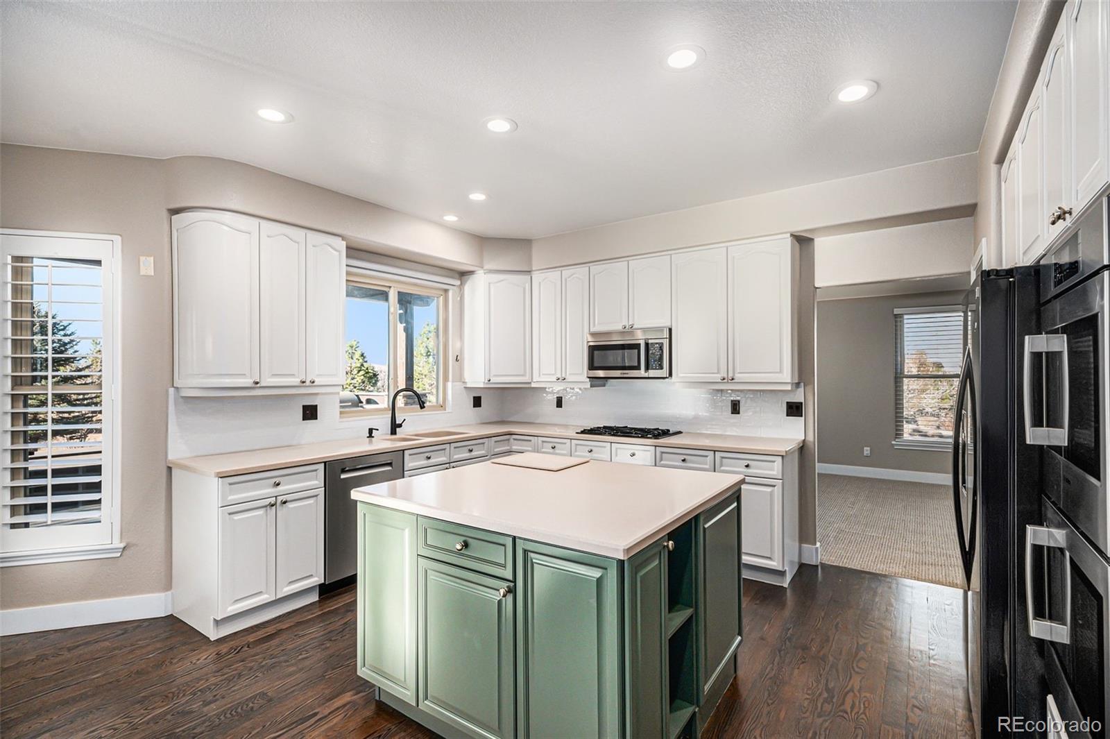 12665 South Robinson Ranch Boulevard Parker, CO 80134 - Photo 11 of 38 a kitchen with a sink stove and refrigerator