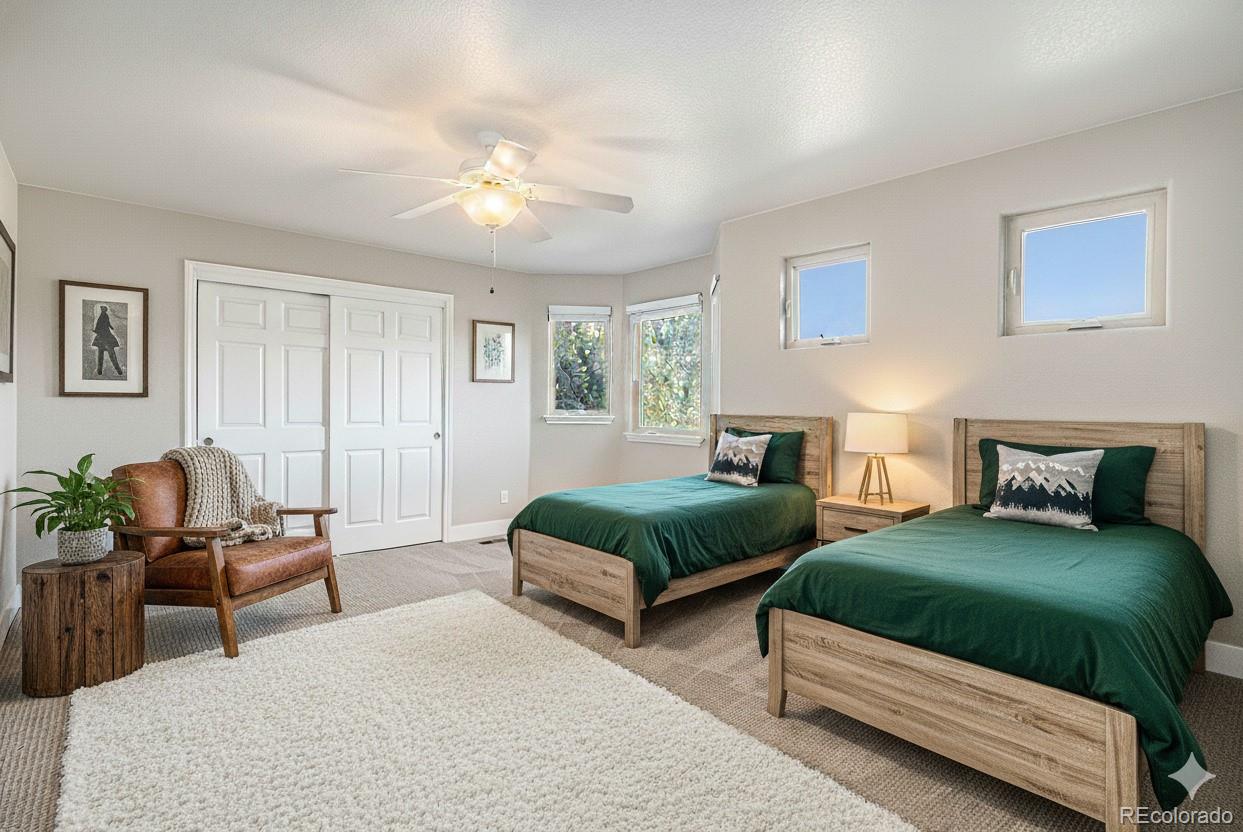 12665 South Robinson Ranch Boulevard Parker, CO 80134 - Photo 23 of 38 a spacious bedroom with two beds and a couch