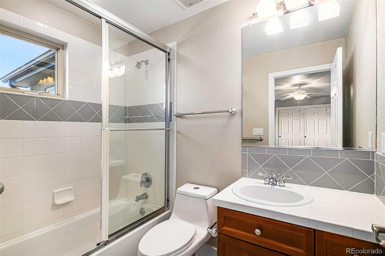 12665 South Robinson Ranch Boulevard Parker, CO 80134 - Photo 24 of 38 a bathroom with a sink a toilet and shower