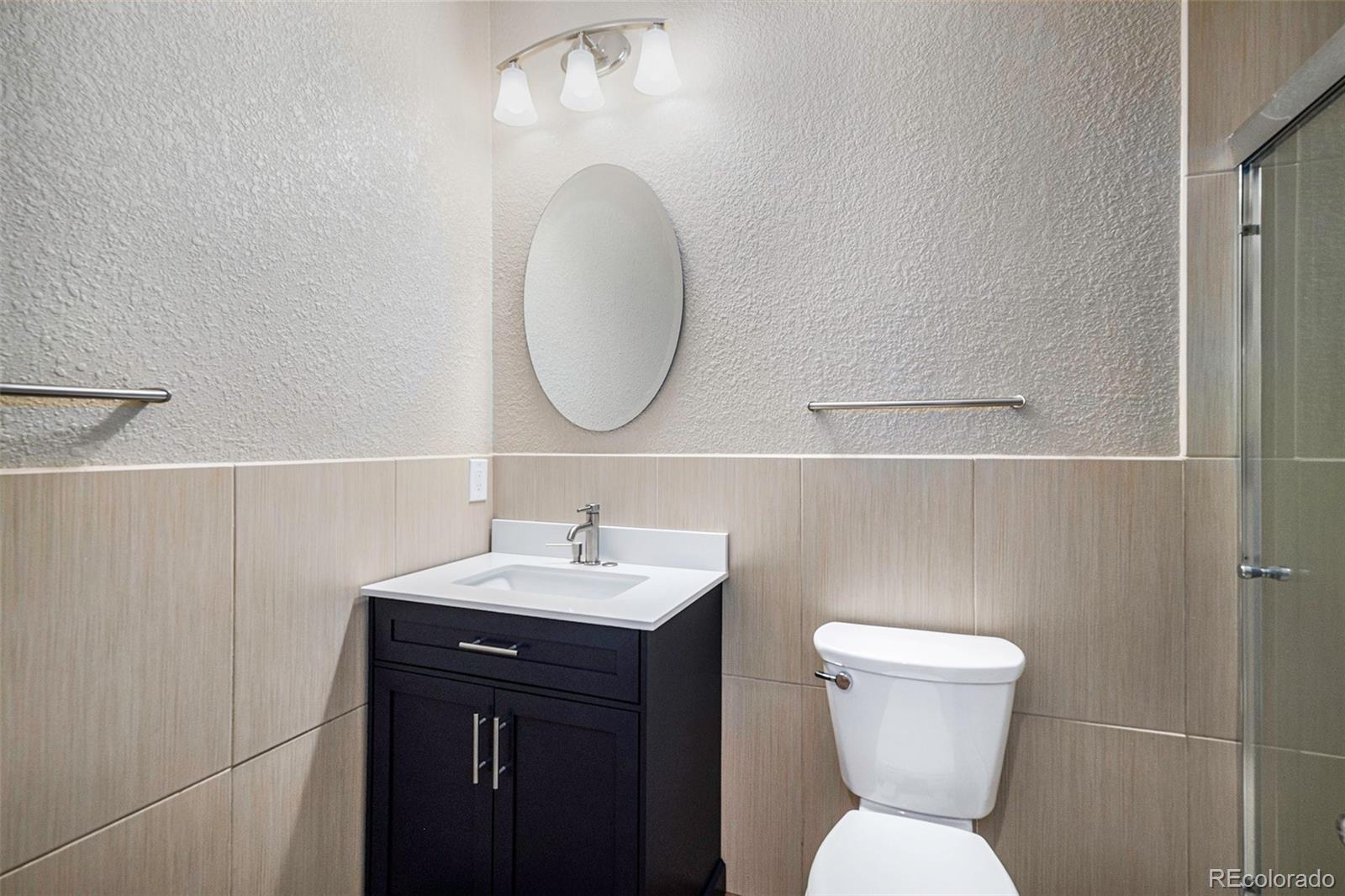 12665 South Robinson Ranch Boulevard Parker, CO 80134 - Photo 27 of 38 a bathroom with a toilet a sink and mirror