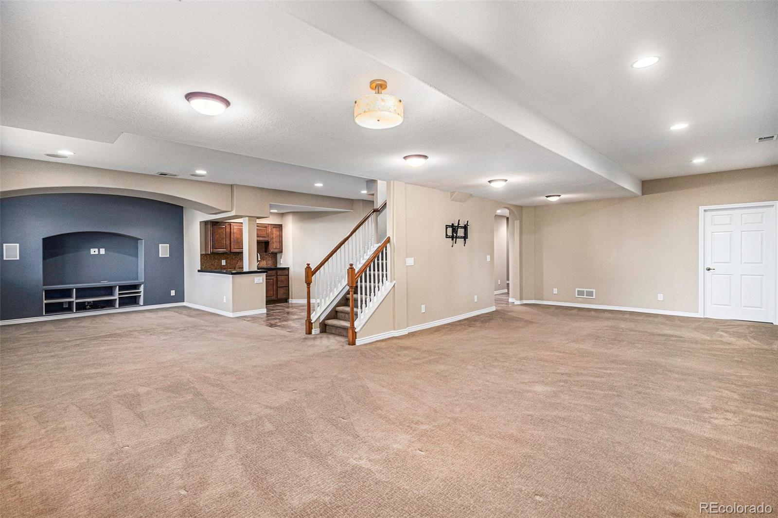 12665 South Robinson Ranch Boulevard Parker, CO 80134 - Photo 29 of 38 an empty room with stairs and a view of living room