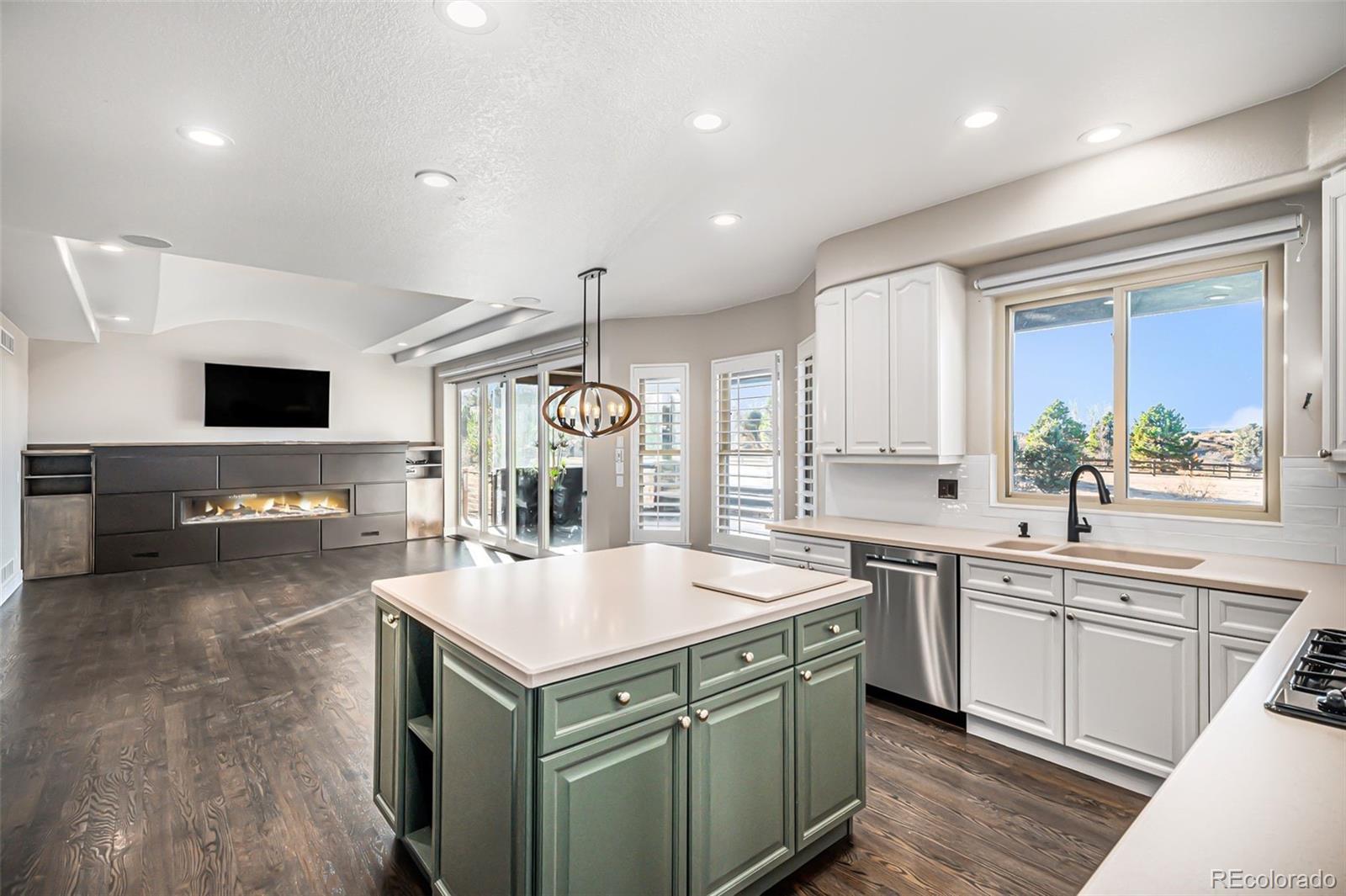 12665 South Robinson Ranch Boulevard Parker, CO 80134 - Photo 9 of 38 a kitchen with a sink a stove and cabinets