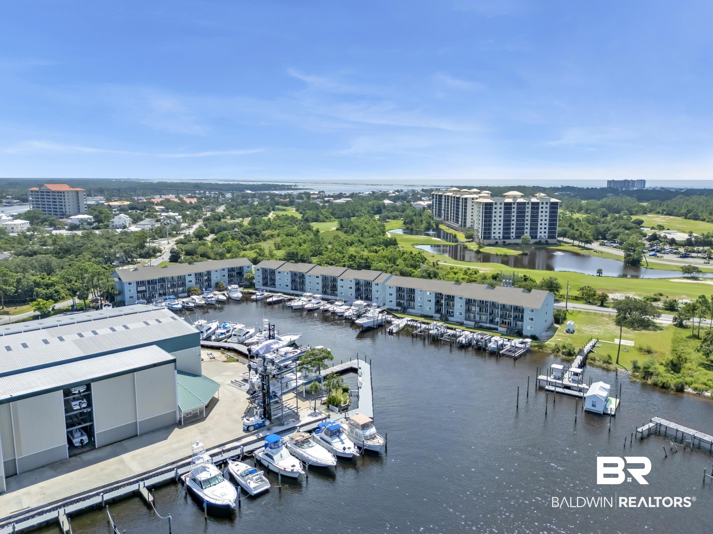 14100 River Road, Unit 211 Pensacola, FL 32507 - Photo 36 of 56 Marina-front properties featuring multiple boat slips, a large boat storage facility, and direct water access