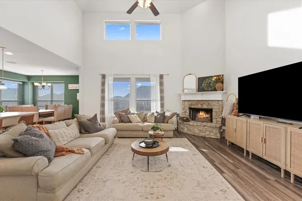 a living room with furniture a flat screen tv and a fireplace