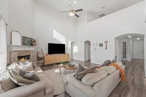 a living room with furniture a flat screen tv and a fireplace