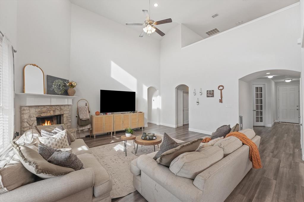 3725 Ranchers Ridge Krum, TX 76249 - Photo 14 of 38 a living room with furniture a flat screen tv and a fireplace