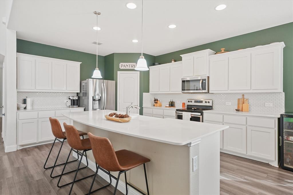 3725 Ranchers Ridge Krum, TX 76249 - Photo 15 of 38 a kitchen with appliances a sink and cabinets