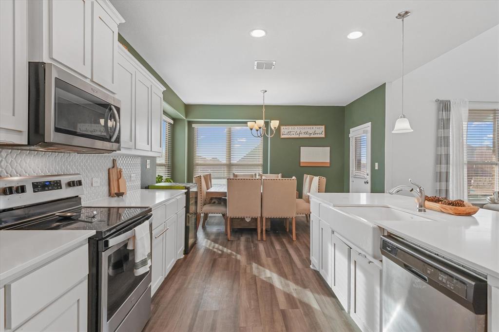 3725 Ranchers Ridge Krum, TX 76249 - Photo 16 of 38 a kitchen with sink stove and cabinets