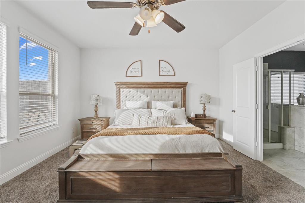 3725 Ranchers Ridge Krum, TX 76249 - Photo 20 of 38 a bedroom with a bed and a chandelier