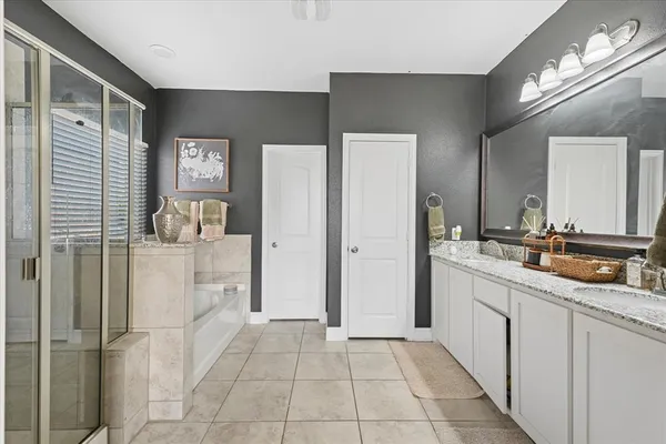 a bathroom with a double vanity sink and mirror