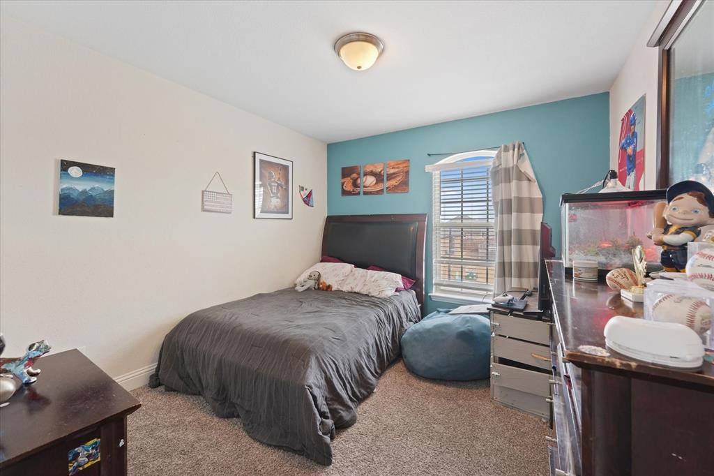 3725 Ranchers Ridge Krum, TX 76249 - Photo 28 of 38 a bedroom with a bed and a chandelier