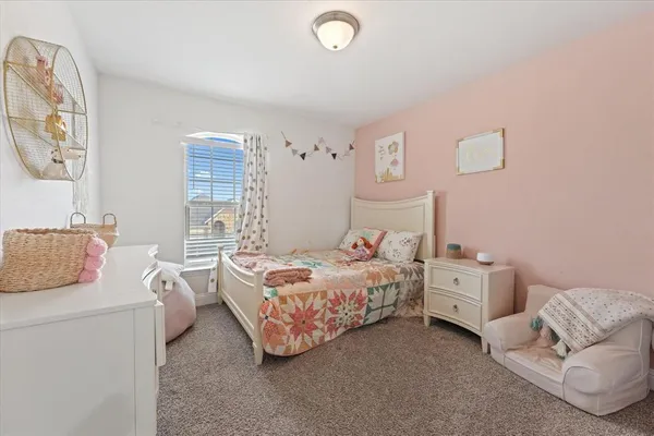 a bedroom with bed and a couch