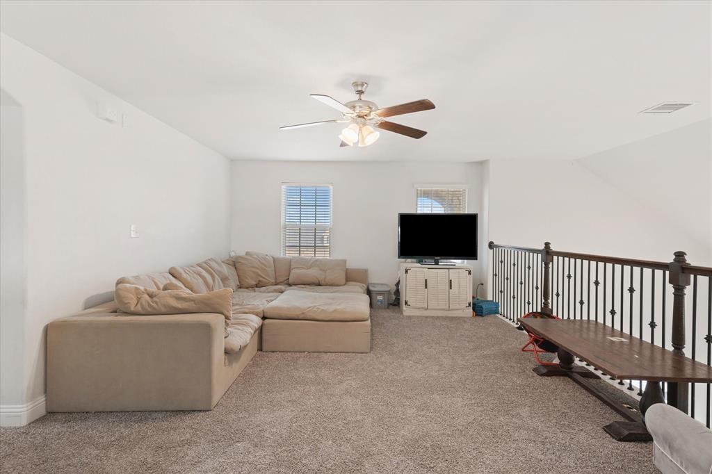 3725 Ranchers Ridge Krum, TX 76249 - Photo 32 of 38 a living room with furniture and a flat screen tv