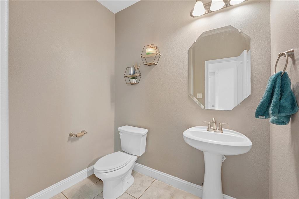 3725 Ranchers Ridge Krum, TX 76249 - Photo 35 of 38 a bathroom with a toilet sink and mirror