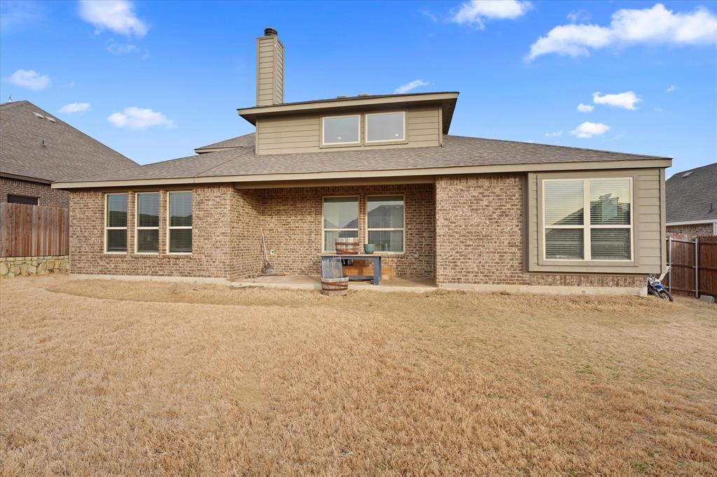 3725 Ranchers Ridge Krum, TX 76249 - Photo 37 of 38 a front view of a house with a yard and garage