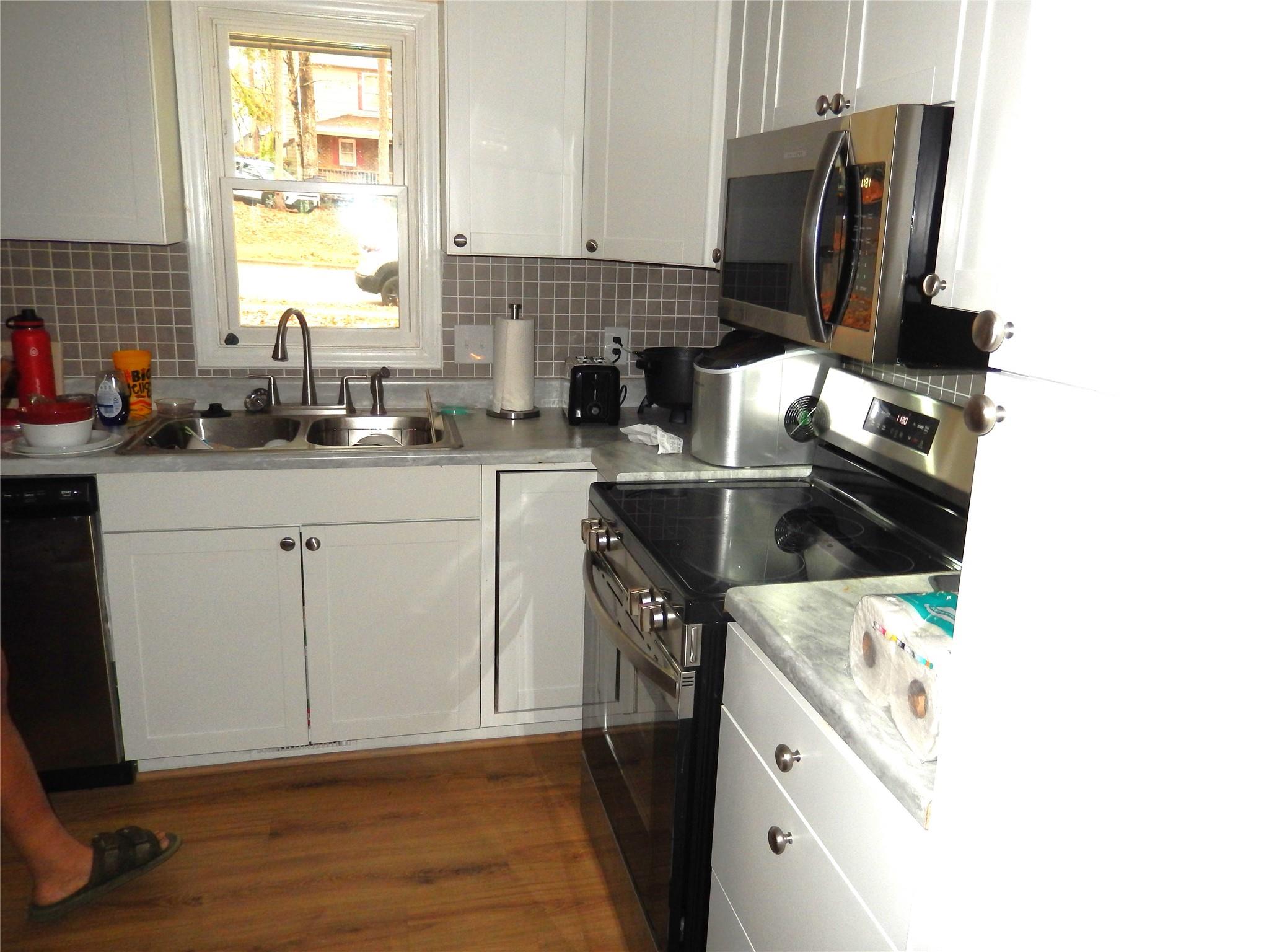 549 Brent Road Raleigh, NC 27606 - Photo 4 of 9 a kitchen with a sink cabinets and a window