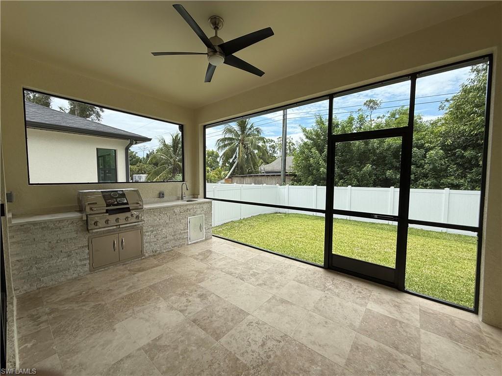 3074 Pine Tree Drive Naples, FL 34112 - Photo 18 of 18 a view of an empty room with a fireplace and a large window