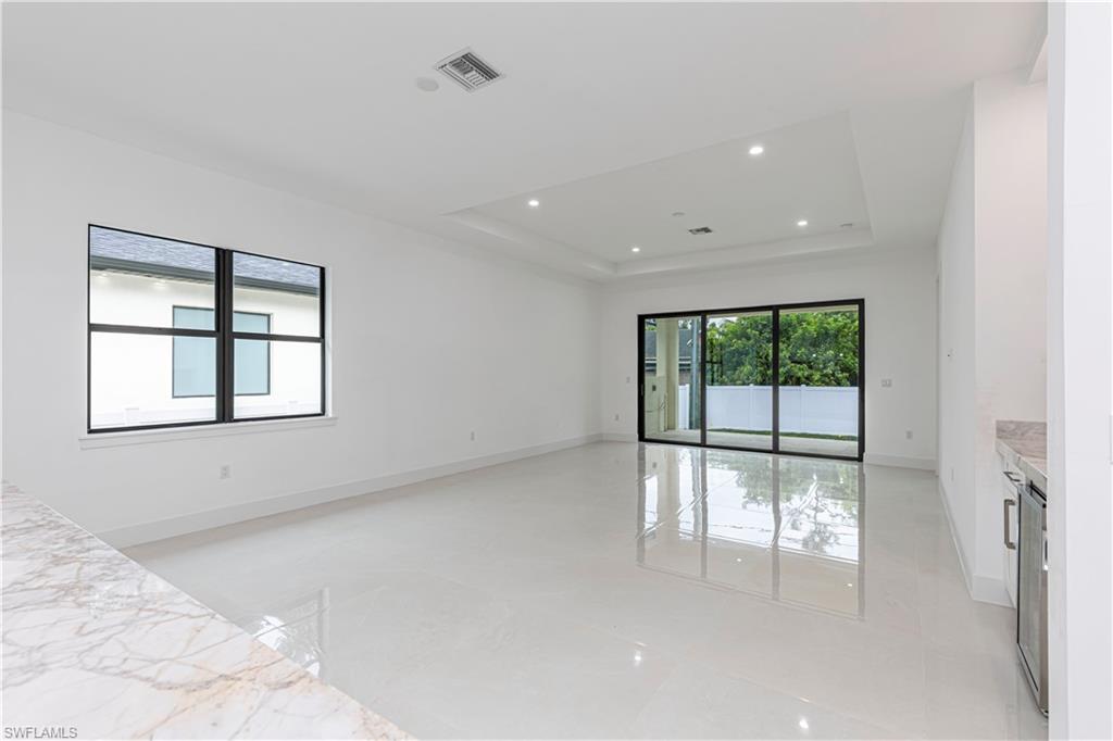 3074 Pine Tree Drive Naples, FL 34112 - Photo 8 of 18 a view of an empty room with a window