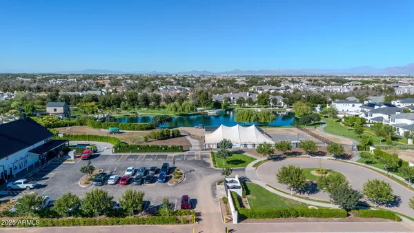 an aerial view of a city with lots of residential buildings ocean and mountain view in back