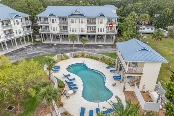 an aerial view of a house with swimming pool and glass windows