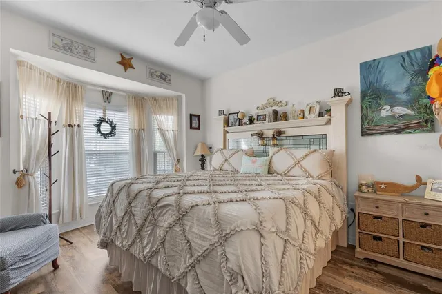 a bed room with a bed and a painting on the wall