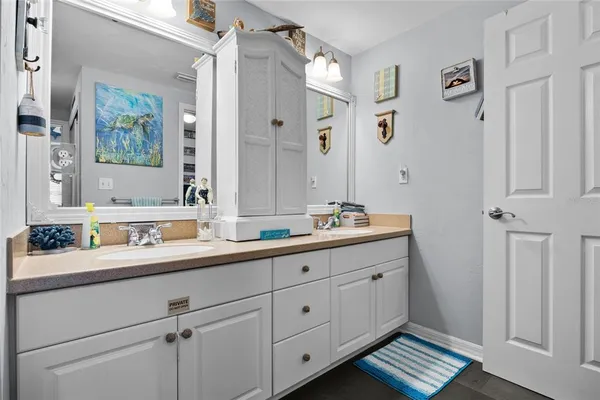 a bathroom with a shower sink and mirror