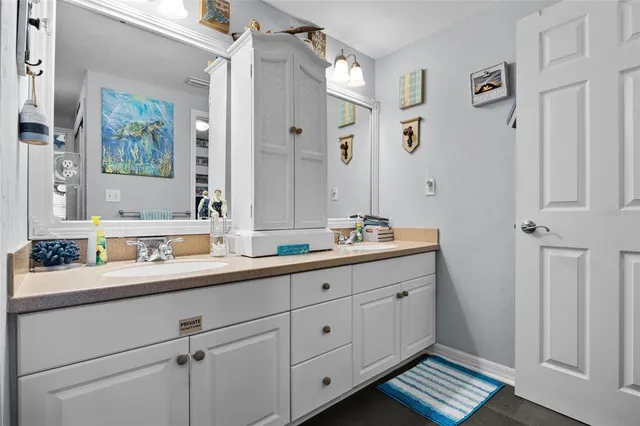 a bathroom with a shower sink and mirror