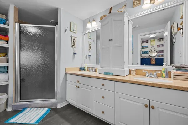 a bedroom with two beds and a painting on the wall