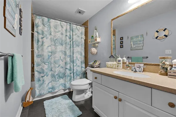 a bedroom with a large bed and a flat tv screen