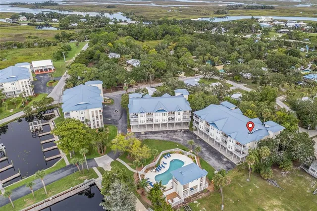 an aerial view of a house with a swimming pool outdoor seating and yard