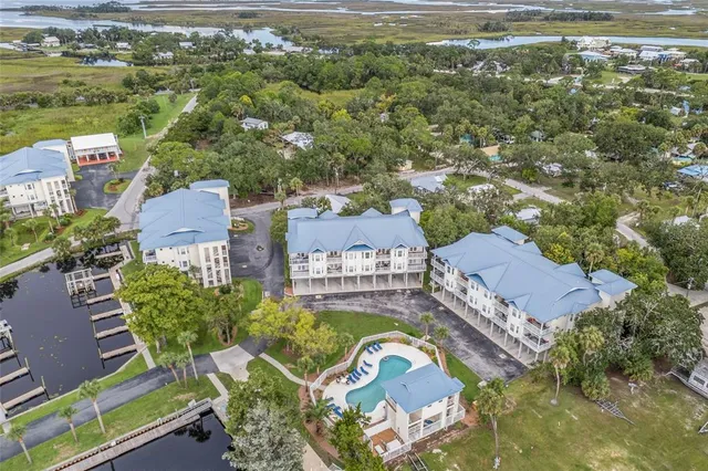 an aerial view of ocean with residential houses with outdoor space
