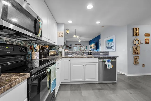 a kitchen with stainless steel appliances granite countertop a stove and a sink