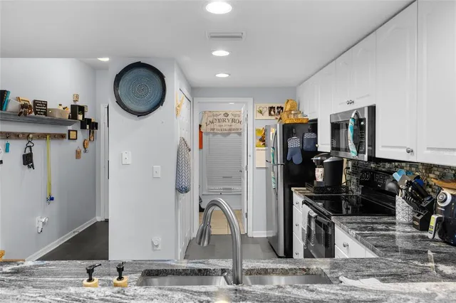 a view of a kitchen with a sink and cabinets