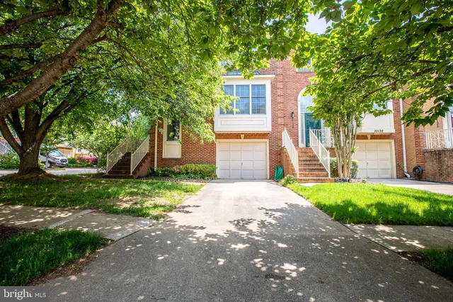 a front view of a house with a yard and a garage