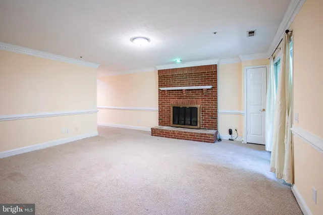 a view of empty room with a fireplace