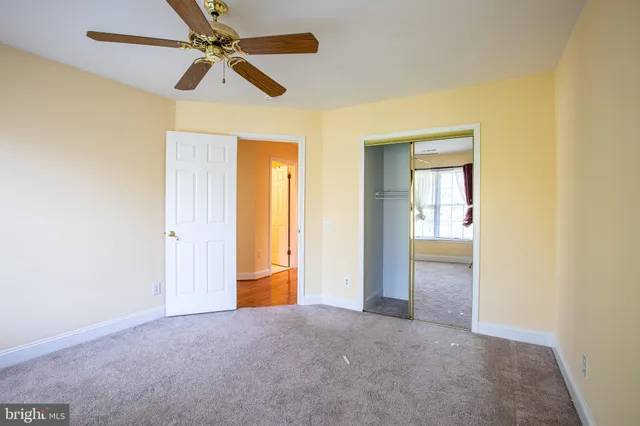 a view of empty room with ceiling fan