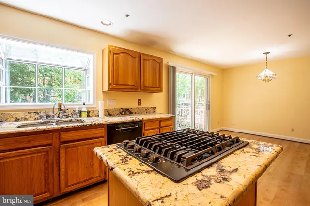 a kitchen with sink stove and cabinets