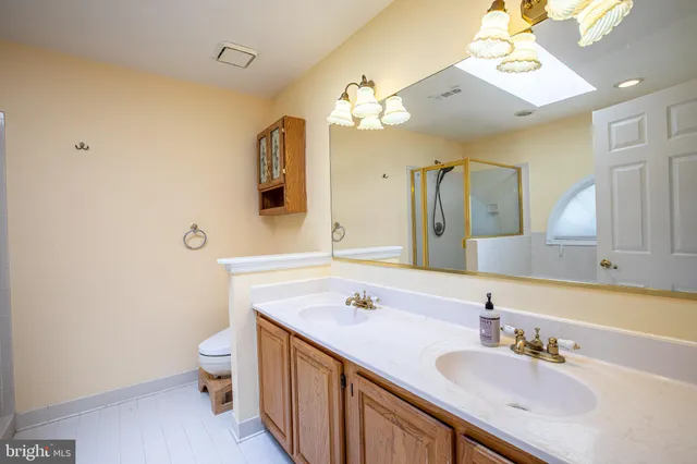 a bathroom with a sink vanity granite and toilet