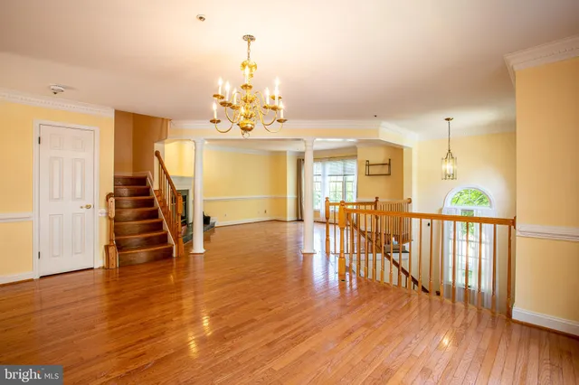 a view of a livingroom with wooden floor and furniture