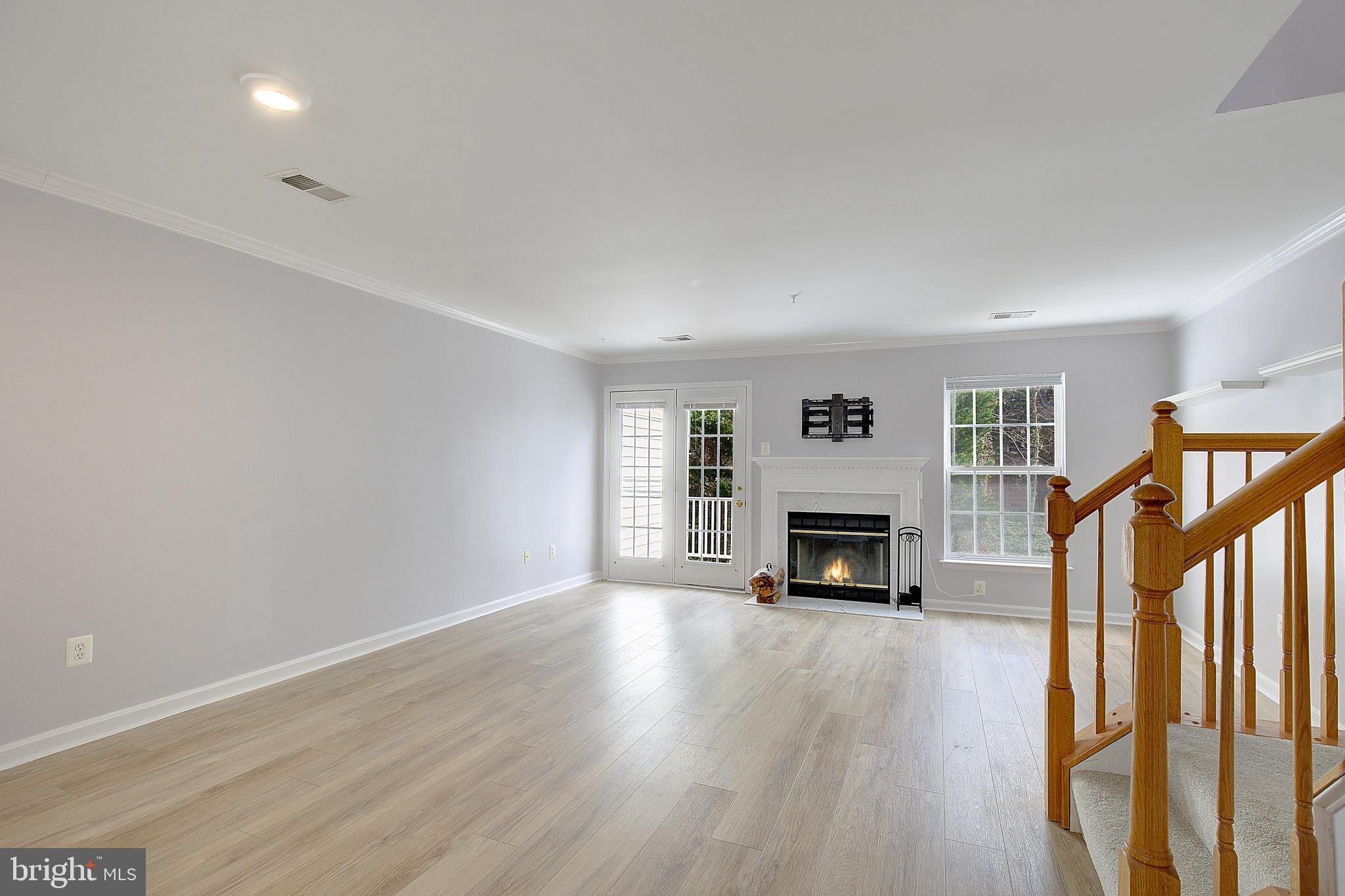 1700 Fallowfield Court Crofton, MD 21114 - Photo 15 of 34 a view of a livingroom with a fireplace wooden floor and window
