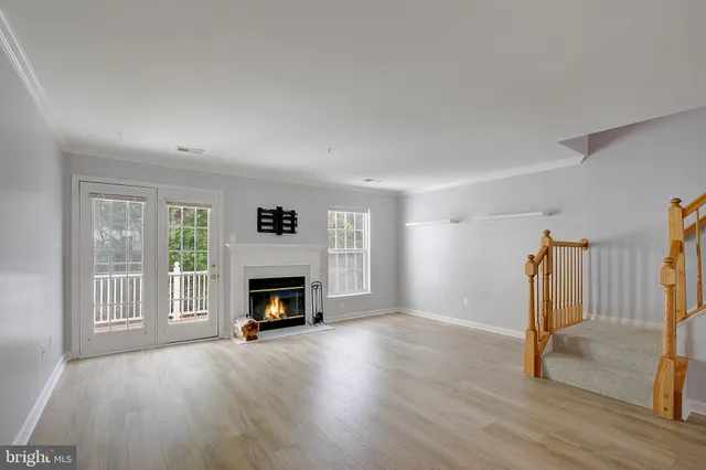 wooden floor fireplace and natural light in room